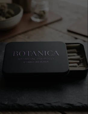 Open Botanica tin of artisanal pre-rolls on slate